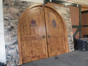 Hand painted wood grained doors painted on Fiberglass. The stone work was also hand painted highlighted with the use of the airbrush.